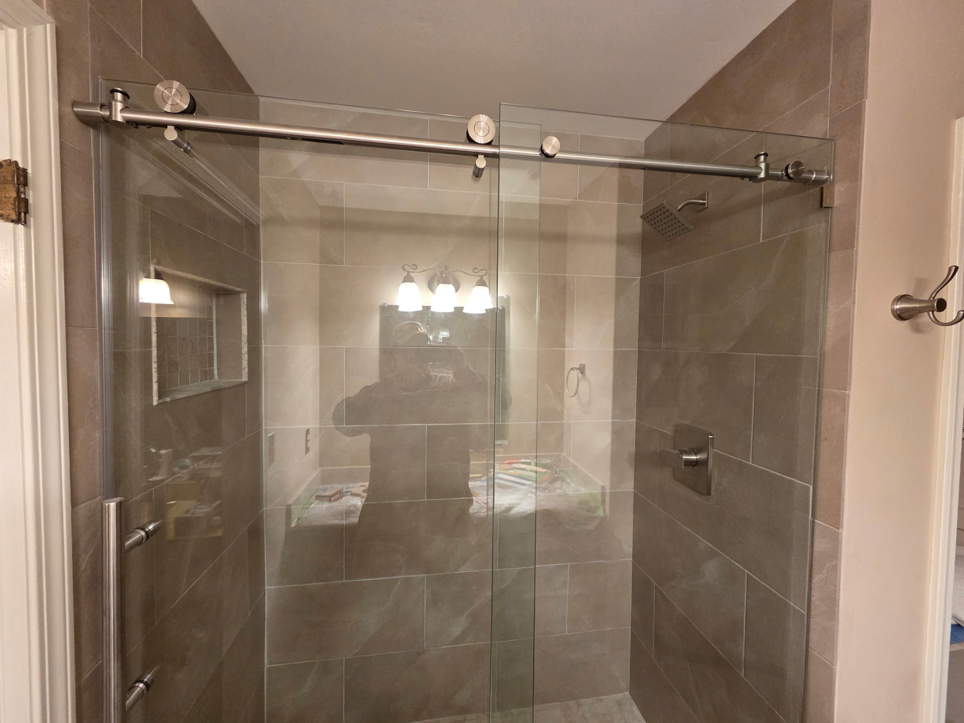 Completed bathroom remodel with sliding glass shower doors
