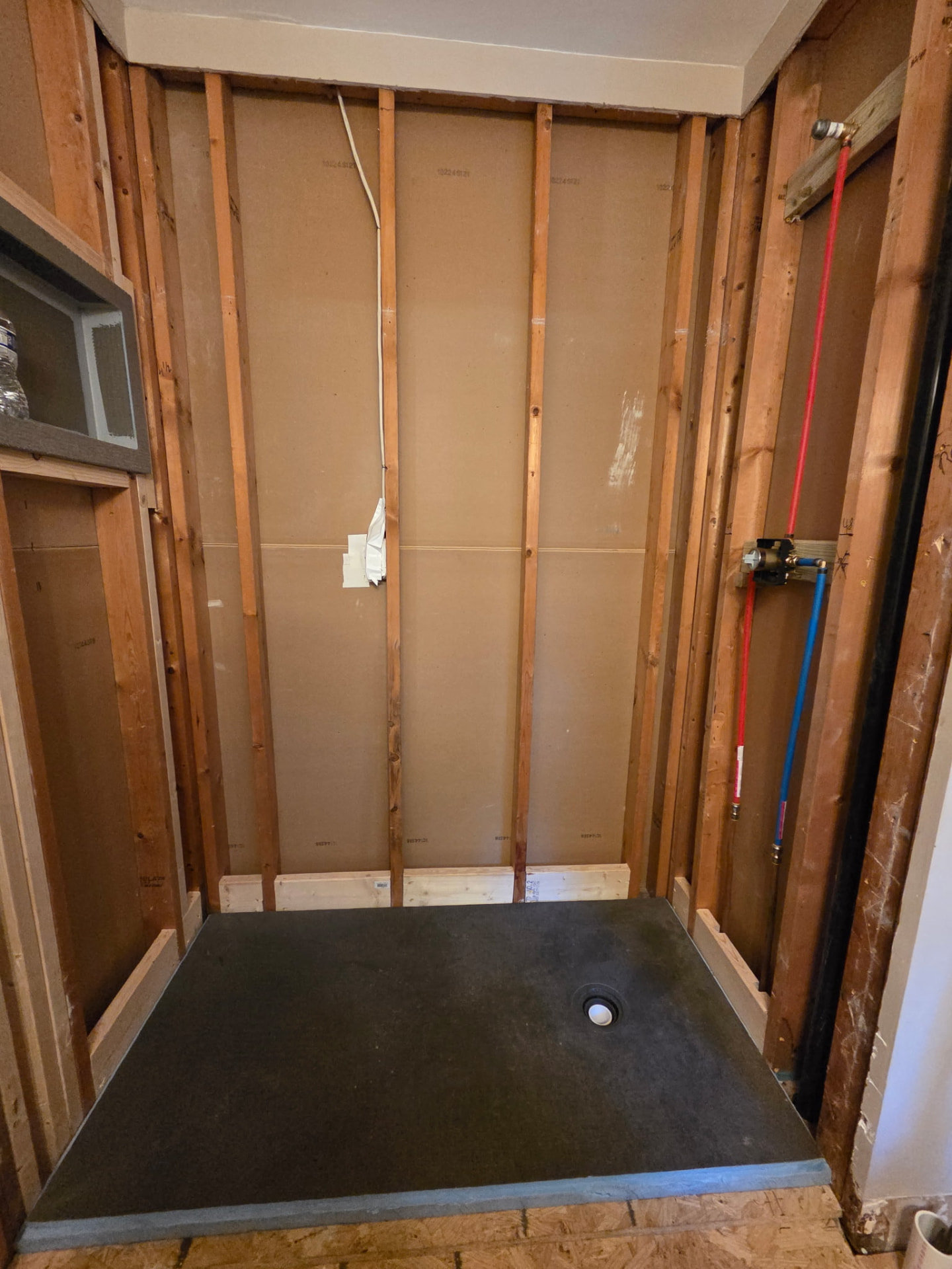 Framed shower alcove with new shower pan and PEX plumbing valve